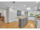 Bright, spacious kitchen featuring white cabinets, an island, and a large stainless refrigerator at 1370 Alberta Dr, Winter Park, FL 32789