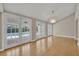 Bright room with vaulted ceilings, modern chandelier, and french doors to the pool at 1370 Alberta Dr, Winter Park, FL 32789