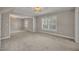 Bright living room with large windows and neutral carpet, perfect for relaxation at 1370 Alberta Dr, Winter Park, FL 32789