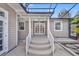 Comfortable outdoor patio with stairs leading down to a manicured yard at 1370 Alberta Dr, Winter Park, FL 32789
