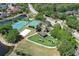 This community aerial highlights tennis and basketball courts, a playground, and easy access to nearby roads at 14021 King Sago Ct, Orlando, FL 32828