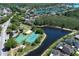 Community aerial view features a lake, basketball and tennis courts, a playground, and well-maintained homes at 14021 King Sago Ct, Orlando, FL 32828