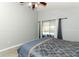Serene bedroom featuring a comfortable queen bed and sliding glass doors to pool area at 14021 King Sago Ct, Orlando, FL 32828