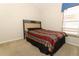 Cozy bedroom featuring a comfortable bed, neutral walls, and a bright window for ample natural light at 14021 King Sago Ct, Orlando, FL 32828