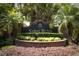 Elegant brick sign welcomes you to Sabal Bend, nestled amidst lush tropical landscaping at 14021 King Sago Ct, Orlando, FL 32828