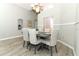 Cozy dining area featuring a gray dining table and comfortable upholstered chairs at 14021 King Sago Ct, Orlando, FL 32828