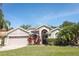 Charming single-Gathering home with a well-manicured lawn and colorful landscaping at 14021 King Sago Ct, Orlando, FL 32828