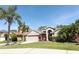 Charming single-Gathering home with a well-manicured lawn, mature palm trees, and a two-car garage at 14021 King Sago Ct, Orlando, FL 32828