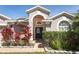Attractive home entrance with decorative plants and a well-maintained walkway at 14021 King Sago Ct, Orlando, FL 32828