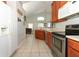 Bright kitchen area with stainless steel appliances, wooden cabinetry, and an open layout to the living space at 14021 King Sago Ct, Orlando, FL 32828