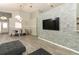 Spacious living room featuring a modern stone accent wall and ample seating at 14021 King Sago Ct, Orlando, FL 32828