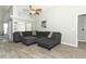 Inviting living room with a comfortable gray sectional sofa and a ceiling fan at 14021 King Sago Ct, Orlando, FL 32828