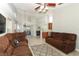 Inviting living room with comfortable brown couches and neutral tile flooring open to dining area at 14021 King Sago Ct, Orlando, FL 32828