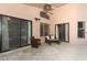 Inviting outdoor patio with comfortable seating area and view of the pool through glass doors at 14021 King Sago Ct, Orlando, FL 32828