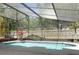 Beautiful screened-in pool surrounded by lush landscaping, offering a private oasis for relaxation at 14021 King Sago Ct, Orlando, FL 32828