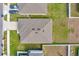 Aerial view of house showing roof, driveway, yard and landscaping at 1511 Finnigan Cir, Haines City, FL 33844
