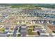 Aerial view of a Primary planned community featuring many homes, lush landscaping and winding streets at 1511 Finnigan Cir, Haines City, FL 33844