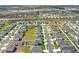Community aerial view with a mix of home styles, green spaces, and a view of distant buildings at 1511 Finnigan Cir, Haines City, FL 33844