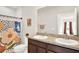 Bathroom featuring a double vanity, framed mirror, floral shower curtain, and coordinated fixtures at 1511 Finnigan Cir, Haines City, FL 33844