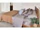 The primary bedroom is furnished with a nightstand, a large bed, and neutral decor at 1511 Finnigan Cir, Haines City, FL 33844