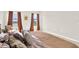 Bright bedroom featuring a plush bed, neutral walls, and soft natural light streaming through large windows at 1511 Finnigan Cir, Haines City, FL 33844