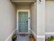 Welcoming front door, nicely painted, with potted flowers, door camera and a cute door mat at 1511 Finnigan Cir, Haines City, FL 33844