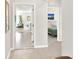 Open hallway featuring tile floors, artwork, and views into the living room and bedroom spaces at 1511 Finnigan Cir, Haines City, FL 33844