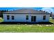Back exterior of home with windows and sliding glass door at 15282 Sw 65Th Avenue Rd, Ocala, FL 34473