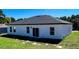 Exterior of home showcasing backyard with sliding glass doors and windows at 15282 Sw 65Th Avenue Rd, Ocala, FL 34473