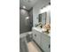 Modern bathroom featuring a glass shower and white vanity with black hardware at 15282 Sw 65Th Avenue Rd, Ocala, FL 34473