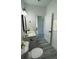 Bright bathroom with white cabinets, modern fixtures, and gray vinyl flooring at 15282 Sw 65Th Avenue Rd, Ocala, FL 34473