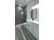Modern bathroom featuring a glass shower and white vanity with black hardware at 15282 Sw 65Th Avenue Rd, Ocala, FL 34473