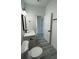Bright bathroom with white cabinets, modern fixtures, and gray vinyl flooring at 15282 Sw 65Th Avenue Rd, Ocala, FL 34473