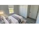 Comfortable bedroom featuring a large window, closet and white bedding at 15282 Sw 65Th Avenue Rd, Ocala, FL 34473