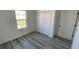 Bright bedroom featuring a large window, closet, and gray floors at 15282 Sw 65Th Avenue Rd, Ocala, FL 34473