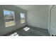 Bright bedroom featuring large windows and gray floors at 15282 Sw 65Th Avenue Rd, Ocala, FL 34473