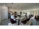 Open concept with dining area and kitchen featuring modern lighting and stainless steel appliances at 15282 Sw 65Th Avenue Rd, Ocala, FL 34473