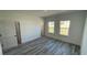 Minimalist bedroom with light gray flooring, neutral walls, and multiple doorways at 15282 Sw 65Th Avenue Rd, Ocala, FL 34473