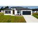 Attractive single-story home featuring well-kept landscaping, an attached garage, and concrete driveway at 15282 Sw 65Th Avenue Rd, Ocala, FL 34473