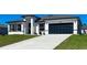 Inviting single-story home with a contemporary facade, concrete driveway, and attached two-car garage at 15282 Sw 65Th Avenue Rd, Ocala, FL 34473