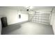 Spacious garage with painted walls and floors and a metal sectional door at 15282 Sw 65Th Avenue Rd, Ocala, FL 34473