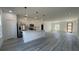 Bright, open kitchen with stainless steel appliances, white cabinetry, and an island; modern design at 15282 Sw 65Th Avenue Rd, Ocala, FL 34473