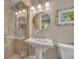 Bathroom featuring a glass shower and pedestal sink with stylish lighting at 1633 Pine Ave, Winter Park, FL 32789