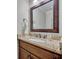 Bathroom with granite countertops, dark wood cabinets, and a decorative mirror at 1633 Pine Ave, Winter Park, FL 32789