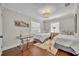 Bedroom featuring two beds, hardwood floors, and a decorative chandelier at 1633 Pine Ave, Winter Park, FL 32789