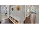 Hallway with storage bench and hat rack with view to another sitting area at 1633 Pine Ave, Winter Park, FL 32789