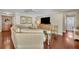 Cozy living room with hardwood floors, a comfortable sectional sofa, and a wooden cabinet with a television at 1633 Pine Ave, Winter Park, FL 32789