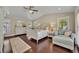 Main bedroom with vaulted ceilings, hardwood floors, and comfortable seating area at 1633 Pine Ave, Winter Park, FL 32789