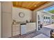 Covered outdoor kitchen area with custom cabinets and brick flooring at 1633 Pine Ave, Winter Park, FL 32789