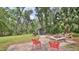 Backyard view of outdoor entertainment area with fire pit and outdoor shed at 1845 Spruce Creek Blvd, Port Orange, FL 32128